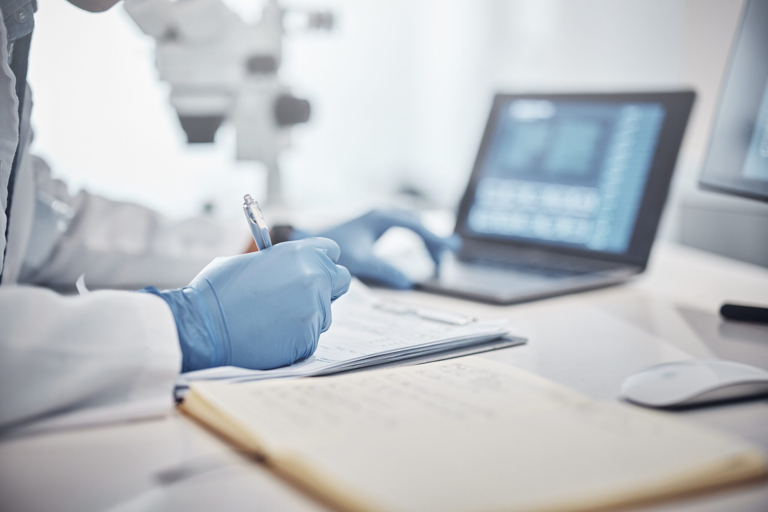 Science, research and hands in lab with notebook and computer on scientific analysis. Experiment, internet and analytics, scientist in laboratory with data, vision and future in medical innovation. provantis